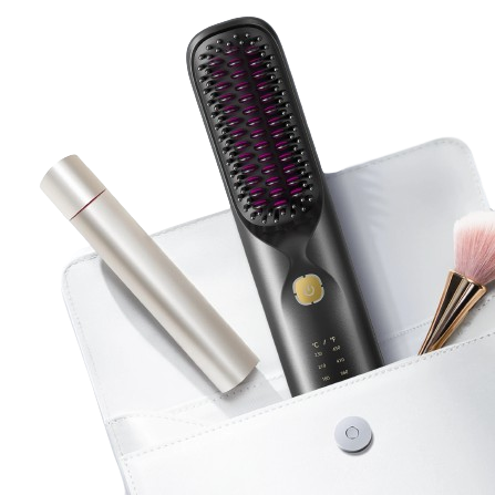 Black hair straightening brush with purple bristle tips on a white surface